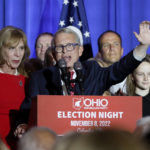 
              Republican Ohio Gov. Mike DeWine, center, speaks during an election night watch party as his wife, Fran, stands next to him Tuesday, Nov. 8, 2022, in Columbus, Ohio. (AP Photo/Jay LaPrete)
            