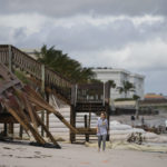 
              People survey damage to the shoreline following the passage of Hurricane Nicole, Thursday, Nov. 10, 2022, in Vero Beach, Fla. (AP Photo/Rebecca Blackwell)
            