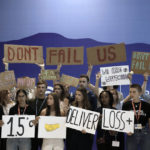 
              Youth activists hold signs encouraging world leaders to maintain policies that limit warming to 1.5 degrees Celsius since pre-industrial times and provide reparations for loss and damage at the COP27 U.N. Climate Summit, Saturday, Nov. 19, 2022, in Sharm el-Sheikh, Egypt. (AP Photo/Nariman El-Mofty)
            