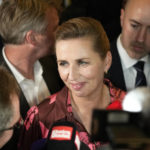 
              Denmark's Prime Minister and head of the Social Democratic Party Mette Frederiksen talks with media members after the country's general election night at the party in Copenhagen, Denmark, early Wednesday, Nov. 2, 2022. Frederiksen was in a strong position to remain in power after her Social Democrats won the most votes in Denmark election Tuesday and a center-left bloc in Parliament that backs appeared set to retain a majority by just one seat. (AP Photo/Sergei Grits)
            