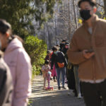 Residents wearing masks line up for COVID tests in Beijing, Tuesday, Nov. 15, 2022. China's ruling party called for strict adherence to the hard-line "zero-COVID" policy Tuesday in an apparent attempt to guide public perceptions after regulations were eased slightly in places. (AP Photo/Ng Han Guan)