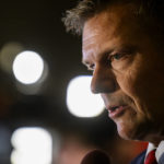 
              Kris Kobach, Republican candidate for attorney general of Kansas, gives television interviews during a Republican watch party in Topeka, Kan., Tuesday, Nov. 8, 2022. (AP Photo/Reed Hoffmann)
            