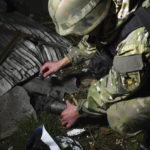 
              Ukrainian police investigator works at the site of the recent Russian shelling in Kramatorsk, Ukraine, Tuesday, Nov. 8, 2022. (AP Photo/Andriy Andriyenko)
            