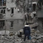 
              A woman stands among debris of the destroyed house after recent Russian air strike in Chasiv Yar, Ukraine, Sunday, Nov. 27, 2022. Shelling by Russian forces struck several areas in eastern and southern Ukraine overnight as utility crews continued a scramble to restore power, water and heating following widespread strikes in recent weeks, officials said Sunday. (AP Photo/Andriy Andriyenko)
            