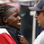 
              Sharon Lokedi, of Kenya, reacts with her coach Stephen Haas after crossing the finish line first in the women's division division of the New York City Marathon, Sunday, Nov. 6, 2022, in New York. (AP Photo/Jason DeCrow)
            