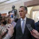 
              Sen. Mitt Romney, R-Utah, is surrounded by reporters as he arrives at the historic Old Senate Chamber where Sen. Rick Scott, R-Fla., is mounting a long-shot bid to unseat Senate Republican leader Mitch McConnell, at the Capitol in Washington, Wednesday, Nov. 16, 2022. (AP Photo/J. Scott Applewhite)
            