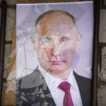 
              A portrait of Russian President Vladimir Putin lies on the ground near the local prison in Kherson, Ukraine, Wednesday, Nov. 16, 2022. The Russian retreat from Kherson marked a triumphant milestone in Ukraine's pushback against Moscow's invasion almost nine months ago. (AP Photo/Efrem Lukatsky)
            