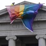 
              A 25-foot historic pride flag is displayed on the exterior of city hall to mark the weekend mass shooting at a gay nightclub Wednesday, Nov. 23, 2022, in Colorado Springs, Colo. The flag, known as Section 93 of the Sea to Sea Flag, is on loan for two weeks to Colorado Springs from the Sacred Cloth Project. (AP Photo/David Zalubowski)
            