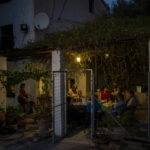 
              Friends and relatives of the Palop family have dinner after the olive harvest in the southern town of Quesada, a rural community in the heartland of Spain's olive country, Saturday, Oct. 29, 2022. (AP Photo/Bernat Armangue)
            