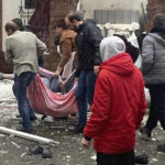 
              In this photo provided by the Kyiv Regional Police, people carry a body at the scene of a Russian shelling in Kyiv, Ukraine, Wednesday, Nov. 23, 2022. Authorities reported power outages in multiple cities of Ukraine, including parts of Kyiv, and in neighboring Moldova after renewed strikes on Wednesday struck Ukrainian infrastructure facilities. (Kyiv Regional Police via AP)
            