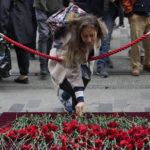 
              A woman leaves a flower at a memorial at the scene of Sunday's explosion on Istanbul's popular pedestrian Istiklal Avenue in Istanbul, Monday, Nov. 14, 2022. Turkey's interior minister says police have detained a suspect who is believed to have planted the bomb that exploded on a bustling pedestrian avenue in Istanbul. He said Monday that initial findings indicate that Kurdish militants were responsible for the attack. (AP Photo/Khalil Hamra)
            