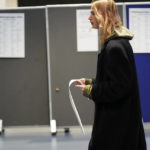 
              A man walks with a ballot before casting at a polling station in Copenhagen, Denmark, on Tuesday, Nov 1, 2022. Denmark's election on Tuesday is expected to change its political landscape, with new parties hoping to enter parliament and others seeing their support dwindle. A former prime minister who left his party to create a new one this year could end up as a kingmaker, with his votes being needed to form a new government. (AP Photo/Sergei Grits)
            