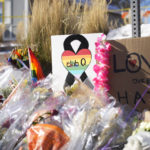 
              Bouquets of flowers sit on a corner near the site of a mass shooting at a gay bar Monday, Nov. 21, 2022, in Colorado Springs, Colo.  Club Q on its Facebook page thanked the "quick reactions of heroic customers that subdued the gunman and ended this hate attack.” (AP Photo/David Zalubowski)
            