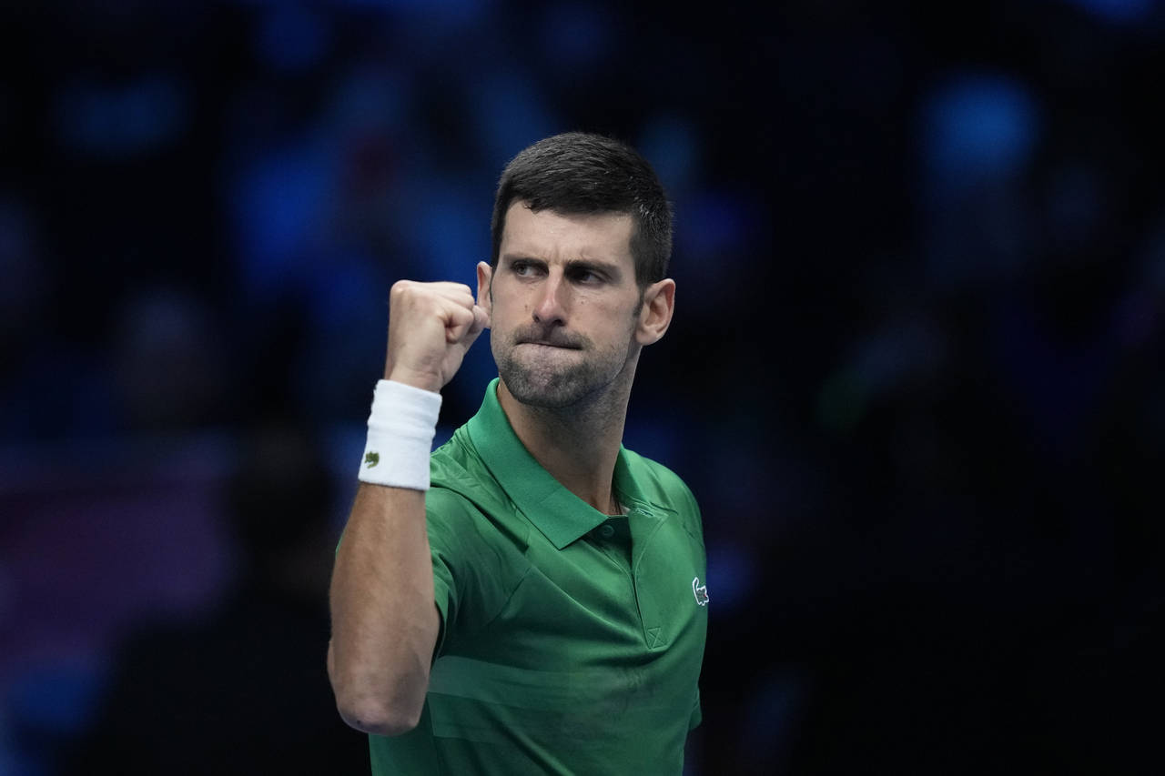 Serbia's Novak Djokovic celebrates after winning against Greece's Stefanos Tsitsipas during their s...
