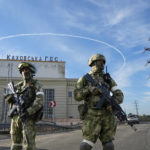 
              FILE - Russian troops guard an entrance of the Kakhovka Hydroelectric Station, a run-of-river power plant on the Dnieper River in the Kherson region, south Ukraine, May 20, 2022. Russia relinquished its final foothold in a major city in southern Ukraine on Friday Nov. 11, 2022, clearing the way for victorious Ukrainian forces to reclaim the country’s only Russian-held provincial capital that could act as a springboard for further advances into occupied territory. (AP Photo/File)
            