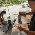 
              FILE - Jamie Holt, lead fisheries technician for the Yurok Tribe, right, and Gilbert Myers count dead chinook salmon pulled from a trap in the lower Klamath River on June 8, 2021, in Weitchpec, Calif. The largest dam demolition and river restoration plan in the world could be close to reality Thursday, Nov. 17, 2022, as U.S. regulators vote on a plan to remove four aging hydro-electric structures, reopening hundreds of miles of California river habitat to imperiled salmon. Several tribes in the region, including the Yurok, have been fighting for years to see the dams come down to aid the recovery of struggling salmon populations. (AP Photo/Nathan Howard, File)
            