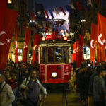 
              A tram rides past the spot of Sunday's explosion on Istanbul's popular pedestrian Istiklal Avenue in Istanbul, Turkey, Monday, Nov. 14, 2022.Turkish police said Monday they have detained a Syrian woman with suspected links to Kurdish militants and that she confessed to planting a bomb that exploded on a bustling pedestrian avenue in Istanbul, killing six people and wounding several dozen others. (AP Photo/Francisco Seco)
            