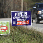 
              FILE - A truck drives by campaign signs opposing and supporting a proposed amendment to the Vermont constitution that would guarantee access to reproductive rights, including abortion, by the side of the road in on Nov. 3, 2022 in Middlesex, Vt. On Nov. 8 five more states will get a gauge of voter sentiment with about abortion, from deep-red Kentucky to purple Michigan to blue California. (AP Photo/Wilson Ring, File)
            
