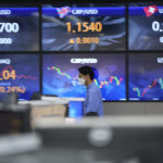 
              A currency trader walks near the screens showing foreign exchange rates at a foreign exchange dealing room in Seoul, South Korea, Wednesday, Nov. 9, 2022. Asian shares were mixed on Wednesday as investors awaited the outcome of the U.S. midterm elections and a major inflation update due later in the week. (AP Photo/Lee Jin-man)
            
