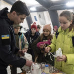 
              A rescue worker makes tea for children at the heating tent "Point of Invincibly" in Bucha, Ukraine, Monday, Nov. 28, 2022. (AP Photo/Evgeniy Maloletka)
            