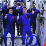 
              In this photo released by Xinhua News Agency, an image captured off a screen at the Jiuquan Satellite Launch Center in northwest China shows the Shenzhou-15 and Shenzhou-14 crew taking a group picture with their thumbs up after a historic gathering in space on Wednesday, Nov. 30, 2022. Three Chinese astronauts docked early Wednesday with their country's space station, where they will overlap for several days with the three-member crew already onboard and expand the facility to its maximum size. (Guo Zhongzheng/Xinhua via AP)
            