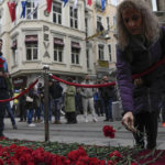 
              People put flowers over a memorial placed on the spot of Sunday's explosion on Istanbul's popular pedestrian Istiklal Avenue in Istanbul, Monday, Nov. 14, 2022. Police have arrested a suspect who is believed to have planted the bomb that exploded on a bustling pedestrian avenue in Istanbul, Turkey’s interior minister said Monday, adding that initial findings indicate that Kurdish militants were responsible for the deadly attack. (AP Photo/Khalil Hamra)
            
