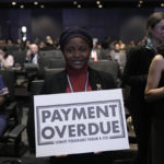
              Nakeeyat Dramani Sam, of Ghana, holds a sign that reads "payment overdue" at the COP27 U.N. Climate Summit, Friday, Nov. 18, 2022, in Sharm el-Sheikh, Egypt. She made a plea for negotiators at the summit to come to an agreement that could help curb global warming. (AP Photo/Nariman El-Mofty)
            