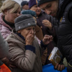 
              A woman reacts after receiving food donations from World Central Kitchen in Kherson, in southern Ukraine, on Thursday, Nov. 17, 2022. (AP Photo/Bernat Armangue)
            