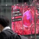 
              A person walks in front of an electronic stock board showing Japan's Nikkei 225 index at a securities firm Monday, Nov. 7, 2022, in Tokyo. Asian stocks mostly rose Monday, as investors weighed uncertainties such as the U.S. mid-term elections and China's possible moves to ease coronavirus restrictions. (AP Photo/Eugene Hoshiko)
            