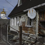 
              A view of buildings damaged by shelling with an Orthodox Church in the background in the liberated village of Shchurove, Donetsk region, Ukraine, Monday, Nov. 7, 2022. (AP Photo/Andriy Andriyenko)
            