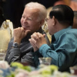 
              FILE - U.S. President Joe Biden, left, and Cambodian Prime Minister Hun Sen share a moment as they watch a cultural dance performance at the Association of Southeast Asian Nations (ASEAN) gala dinner, Saturday, Nov. 12, 2022, in Phnom Penh, Cambodia. Hun Sen said Tuesday, Nov. 15, 2022, he has tested positive for COVID-19 at the Group of 20 meetings in Bali, just days after hosting many world leaders, including President Joe Biden, for a summit in Phnom Penh. (AP Photo/Alex Brandon, File)
            