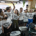 
              A group of protesters wear T-shirts with #FREEALAA after a panel with Sanaa Seif, sister of Egypt's jailed leading pro-democracy activist Alaa Abdel-Fattah, who is on a hunger and water strike, at the COP27 U.N. Climate Summit, Tuesday, Nov. 8, 2022, in Sharm el-Sheikh, Egypt. (AP Photo/Nariman El-Mofty)
            