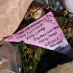 
              Names of the five victims are hand-written on a tribute placed at a makeshift memorial near the scene of a mass shooting at a gay nightclub Wednesday, Nov. 23, 2022, in Colorado Springs, Colo. The alleged shooter facing possible hate crime charges in the fatal shooting of five people at a Colorado Springs gay nightclub is scheduled to make their first court appearance Wednesday from jail after being released from the hospital a day earlier.   (AP Photo/David Zalubowski)
            
