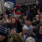 
              Residents gathering at an aid distribution point receive supplies in downtown Kherson, southern Ukraine, Friday, Nov. 18, 2022. (AP Photo/Bernat Armangue)
            