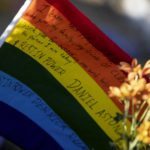 
              A flag with a message to Daniel Aston, one of the victims of the mass shooting at Club Q, sits at a memorial outside the club Monday, Nov. 21, 2022, in Colorado Springs, Colo. (AP Photo/Parker Seibold)
            