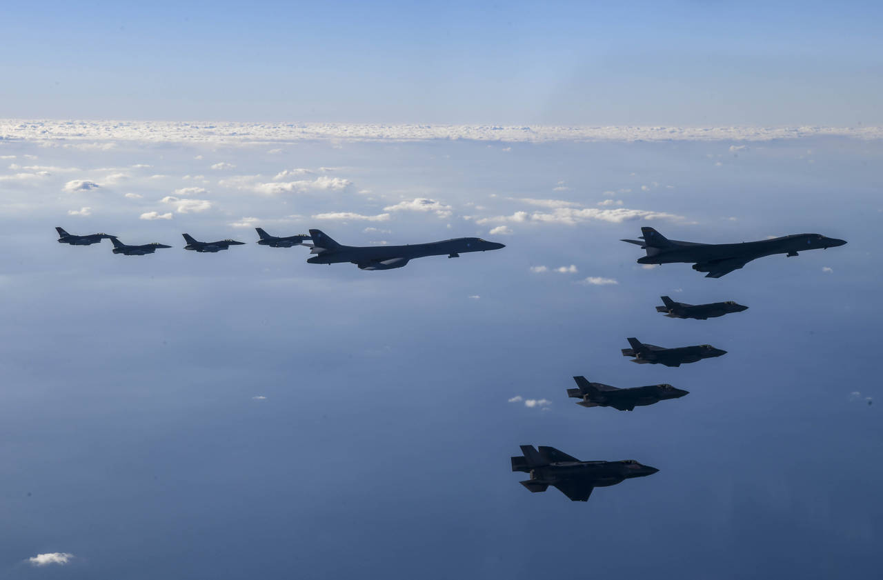 In this photo provided by South Korean Defense Ministry, two U.S. Air Force B-1B bombers, top cente...
