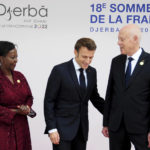 
              Tunisian President Kais Saied, right, and Louise Mushikiwabo, Secretary-General of the Organisation internationale de la Francophonie, left, receive French president Emmanuel Macron during the opening ceremony of the 18th Francophone Summit, in Djerba, Tunisia, Saturday, Nov. 19, 2022. (AP Photo/Hassene Dridi)
            