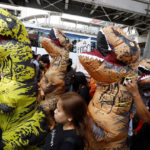 
              Protesters wear dinosaur costumes during a demonstration near the Asia-Pacific Economic Cooperation (APEC) forum venue, Thursday, Nov. 17, 2022, in Bangkok Thailand. A small but noisy group of protesters scuffled briefly with police demanding to deliver a letter to leaders attending the summit demanding various causes including removal of Prime Minister Prayuth Chan-ocha and abolition of Thailand's strict royal defamation laws. (AP Photo/Sarot Meksophawannakul)
            