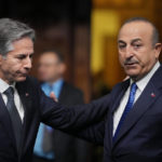 
              Turkey's Foreign Minister Mevlut Cavusoglu, right, talks with United States Secretary of State Antony Blinken as they arrive for a family photo during the first day of the meeting of NATO Ministers of Foreign Affairs, in Bucharest, Romania, Tuesday, Nov. 29, 2022. (AP Photo/Andreea Alexandru)
            