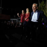 
              Texas Gov. Greg Abbott arrives to speaks during an election night party Tuesday, Nov. 8, 2022, in McAllen, Texas, with his wife Cecilia Abbott and daughter Audrey. (AP Photo/David J. Phillip)
            
