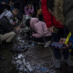 
              Residents plug in mobile phones and power banks at a charging point in downtown Kherson, southern Ukraine, Sunday, Nov. 20, 2022. Russian forces fired tank shells, rockets and other artillery on the city of Kherson, which was recently liberated from Ukrainian forces. (AP Photo/Bernat Armangue)
            