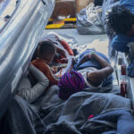 
              Migrants lay on the deck of the Rise Above rescue ship run by the German organization Mission Lifeline, in the Mediterranean Sea off the coasts of Sicily, southern Italy, Sunday, Nov. 6, 2022. Italy allowed one rescue ship, the German run Humanity 1, to enter the Sicilian port and begin disembarking minors, but refused to respond to requests for safe harbor from three other ships carrying 900 more people in nearby waters. (Severine Kpoti/Mission Lifeline Via AP)
            