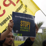 
              A demonstrator holds a sign that reads "give agroecology a chance" at the COP27 U.N. Climate Summit, Thursday, Nov. 17, 2022, in Sharm el-Sheikh, Egypt. (AP Photo/Peter Dejong)
            