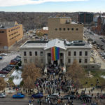 
              In this aerial image taken with a drone, a rainbow flag is unfurled at City Hall Wednesday, Nov. 23, 2022, in Colorado Springs, Colo. With a growing and diversifying population, the city nestled at the foothills of the Rockies is a patchwork of disparate social and cultural fabrics. But last weekend’s shooting has raised uneasy questions about the lasting legacy of cultural conflicts that caught fire decades ago and gave Colorado Springs a reputation as a cauldron of religion-infused conservatism, where LGBTQ people didn't fit in with the most vocal community leaders' idea of family values (AP Photo/Brittany Peterson)
            