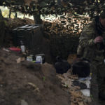 
              FILE - A Ukrainian serviceman checks the trenches dug by Russian soldiers in a retaken area in Kherson region, Ukraine, Oct. 12, 2022. Russia relinquished its final foothold in a major city in southern Ukraine on Friday Nov. 11, 2022, clearing the way for victorious Ukrainian forces to reclaim the country’s only Russian-held provincial capital that could act as a springboard for further advances into occupied territory. (AP Photo/Leo Correa, File)
            