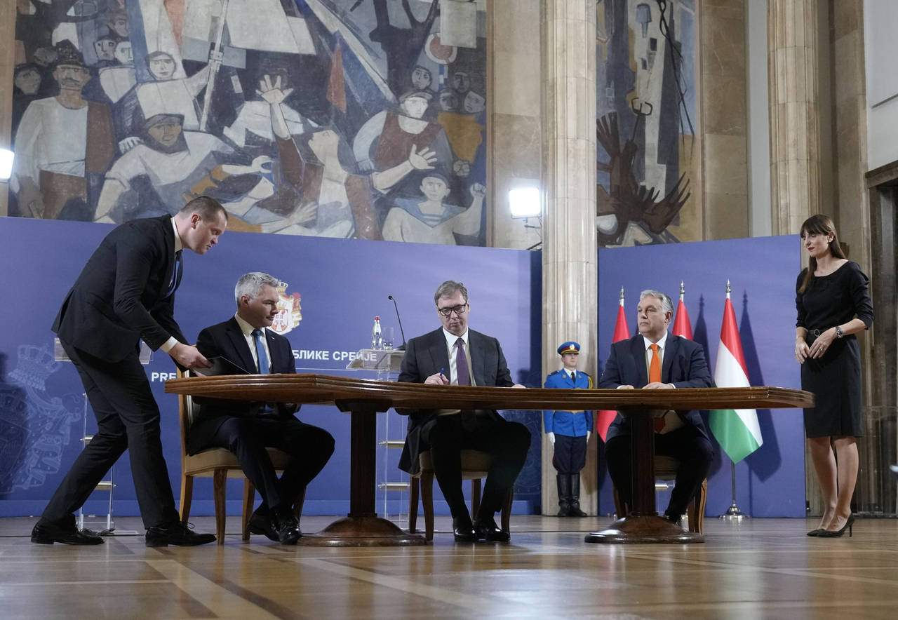 Hungary's Prime Minister Viktor Orban, right, Serbian President Aleksandar Vucic, center, and Austr...