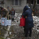 
              Local residents react near the destroyed house after recent Russian air strike in Chasiv Yar, Ukraine, Sunday, Nov. 27, 2022. Shelling by Russian forces struck several areas in eastern and southern Ukraine overnight as utility crews continued a scramble to restore power, water and heating following widespread strikes in recent weeks, officials said Sunday. (AP Photo/Andriy Andriyenko)
            