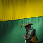 
              A supporter of Brazilian President Jair Bolsonaro walks past a giant national flag during a protest against his defeat in the country's presidential runoff, outside a military base in Sao Paulo, Brazil, Thursday, Nov. 3, 2022. Some supporters are calling on the military to keep Bolsonaro in power, even as his administration signaled a willingness to hand over the reins to his rival, President-elect Luiz Inacio Lula da Silva. (AP Photo/Matias Delacroix)
            