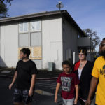 
              Kim Carlson, third from left, her two grandsons and community organizer Devin Williams, right, walk around the Delta Pines apartment complex, Friday, Nov. 4, 2022, in Antioch, Calif. Despite a landmark renter protection law approved by California legislators in 2019, tenants across the country’s most populous state are taking to ballot boxes and city councils to demand even more safeguards. They want to crack down on tenant harassment, shoddy living conditions and unresponsive landlords that are usually faceless corporations. (AP Photo/Godofredo A. Vásquez)
            