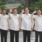 
              FILE - APEC leaders wearing the traditional "barong tagalog" from the Philippines wave during a group photo in Subic Bay, west of Manila. From left: then Australian Prime Minister John Howard, Brunei's sultan Hassanal Bolkiah, then Chilean President Eduardo Frei, then Chinese President Jiang Zemin, then Hong Kong Financial Secretary Donald Tsang, and then Indonesian President Suharto., Nov. 25, 1996. Chinese state TV said Wednesday, Nov. 30, 2022, that Jiang has died at age 96. (AP Photo/Bullit Marquez, File)
            